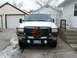 2000 Ford F-250 - This 2000 Ford F-250 is seen from the front, decorated for the holidays with a wreath on its grille and a license plate reading HUY 822.