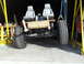 1992 Ford Bronco - A custom-built vehicle chassis with seats is being worked on, suspended by cranes in a garage.