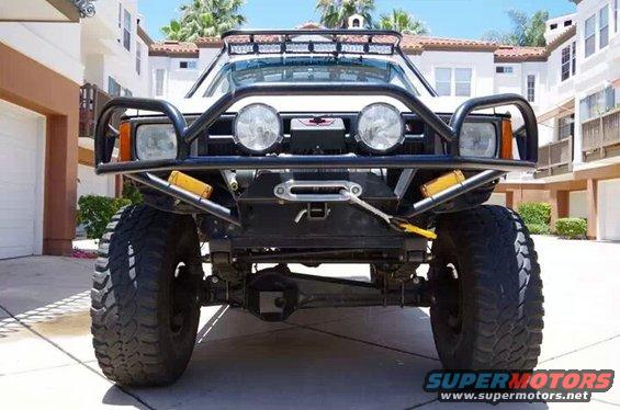 Front view of white off-road SUV with winch and light bar