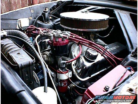 Engine bay with red spark plug wires and chrome valve covers