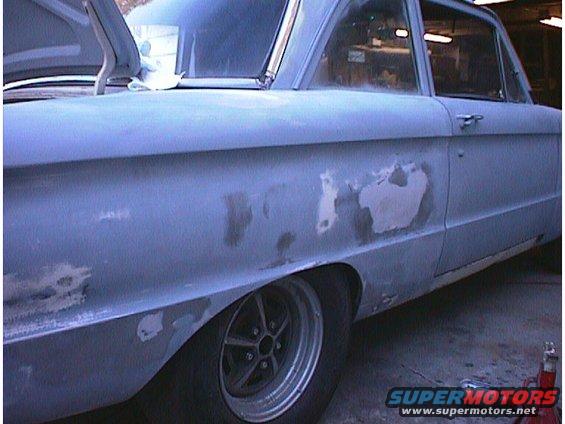 1960 Ford Falcon side view, body in primer with visible filler patches. Hood is open