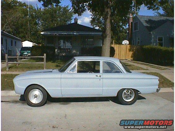 Light blue 1960 Ford Falcon sedan, side view, primer finish, custom wheels