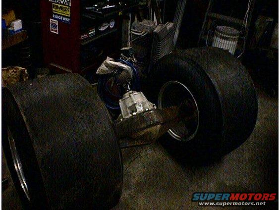 Rear axle with two large tires and differential in a workshop