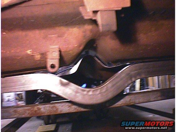 Undercarriage view of a car part with Supermotors.net logo