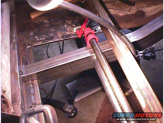 Close-up of vehicle underbody with metal framing and repair work visible