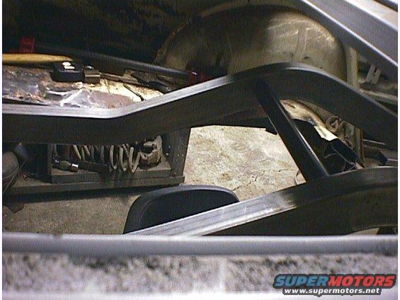 Car interior with exposed metal frame, springs, and tools