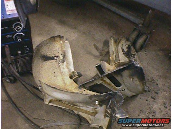 Damaged car bumper with welding equipment nearby
