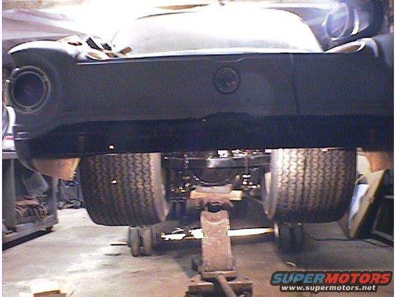 1960 Ford Falcon rear axle and tires on jack stands