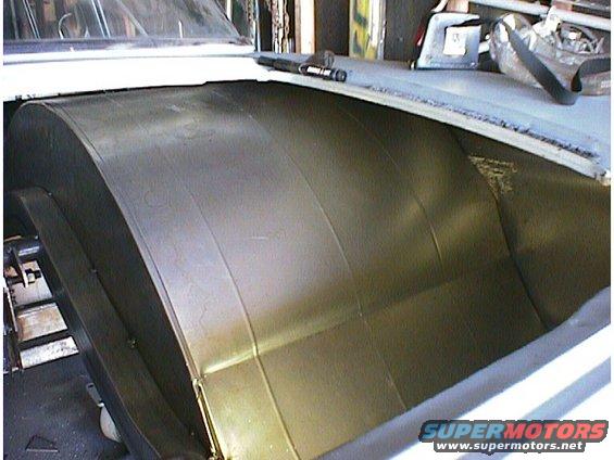 Interior view of a car's metal paneling, possibly a trunk or rear seat area