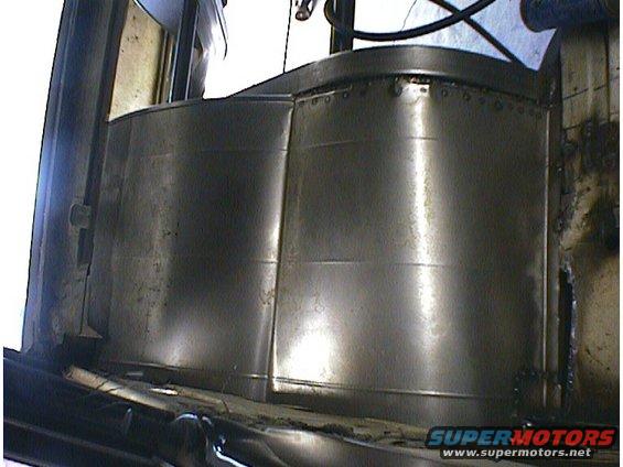 Metal panels with rivets inside a vehicle's interior, showing a curved shape