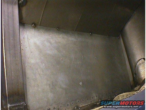 Interior metal paneling with visible rivets and welds