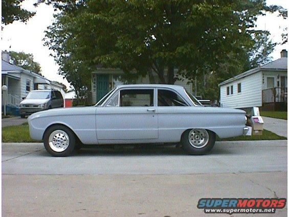 Light blue 1960 Ford Falcon sedan, side view, with custom wheels and primer finish