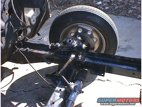close-up of vehicle chassis with front wheel and suspension components