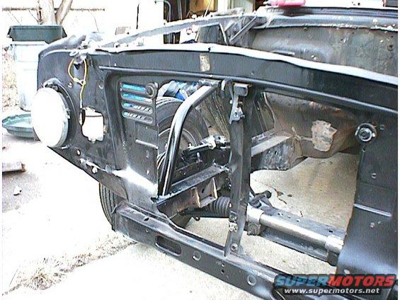 Black 1960 Ford Falcon frame, front view, showing engine bay structure and suspension components