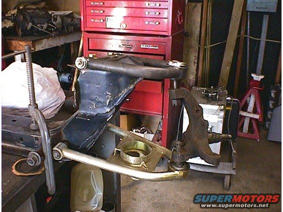 Front suspension components with a red toolbox in the background