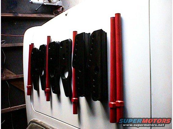 Black and red parts mounted on a white surface