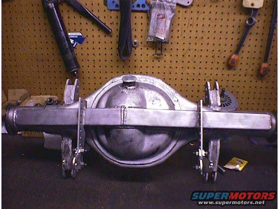 Rear axle assembly with fabricated U-bolt plates and shock mounts