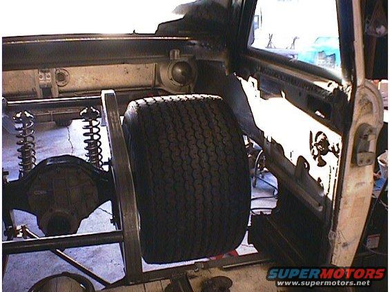 Interior view of a car with large tire and rear axle assembly