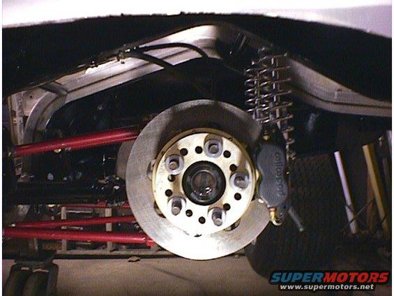 Rear brake rotor and caliper assembly with red suspension arms