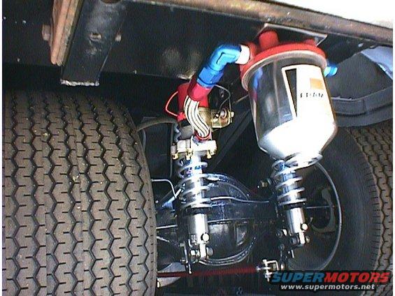aftermarket fuel filter, braided lines, and coilover shocks mounted to a rear axle