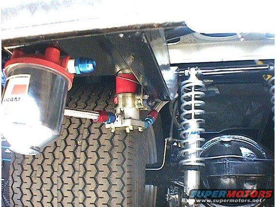 Close-up of a fuel filter and rear suspension with coilover shocks