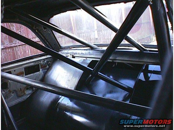 Interior of a 1960 Ford Falcon with a roll cage and black upholstery
