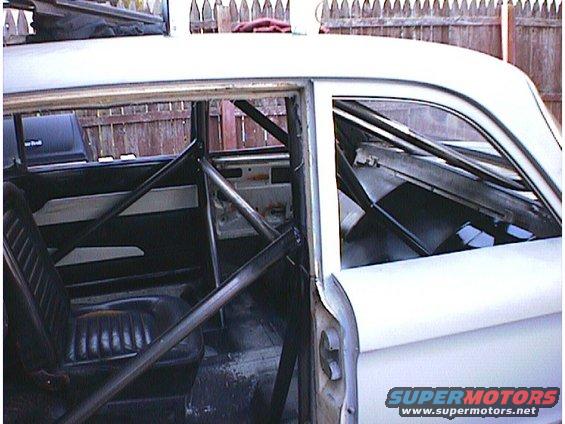 1960 Ford Falcon interior with roll cage and bucket seats