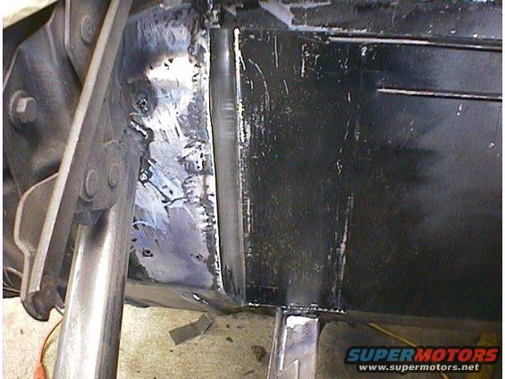 Close-up of metal frame section with fresh welds and black paint