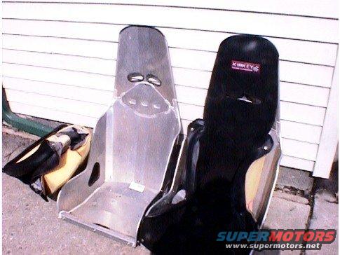 Two racing seats, one aluminum and one black with a red KIKKEY logo