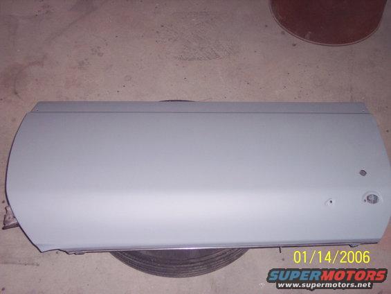 Gray car door with date stamp and Supermotors logo