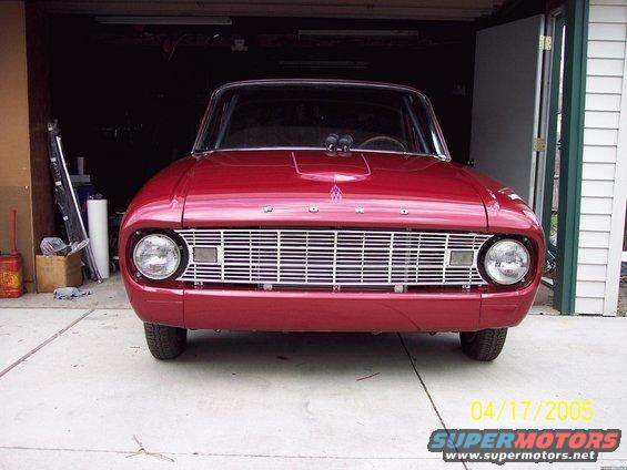 Red 1960 Ford Falcon front view with chrome grille and hood scoop