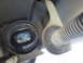 2003 Ford Taurus - Close-up view of a vehicle's suspension strut and bushing assembly.