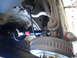 2003 Ford Taurus - Close-up view of a vehicle's rear suspension strut and drum brake assembly, showing suspension components and brake hardware.
