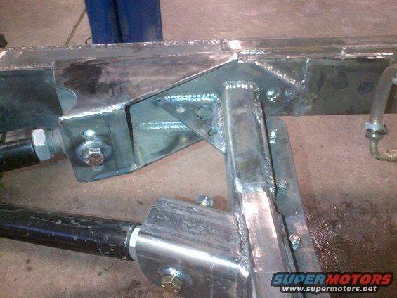 Close-up of custom Jeep CJ frame with suspension components and welding