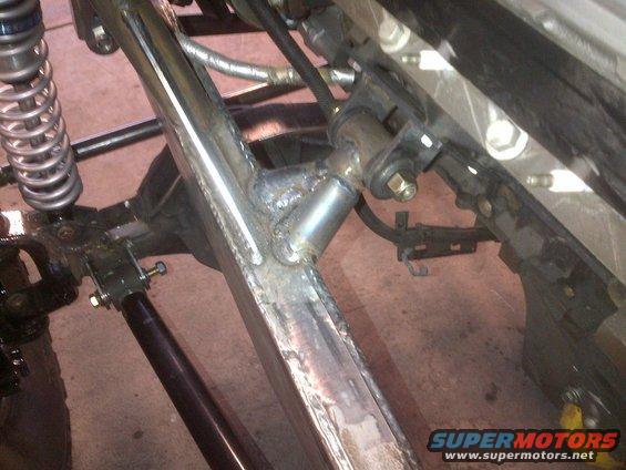 Custom welded frame section with silver coilover shock and black drive shaft