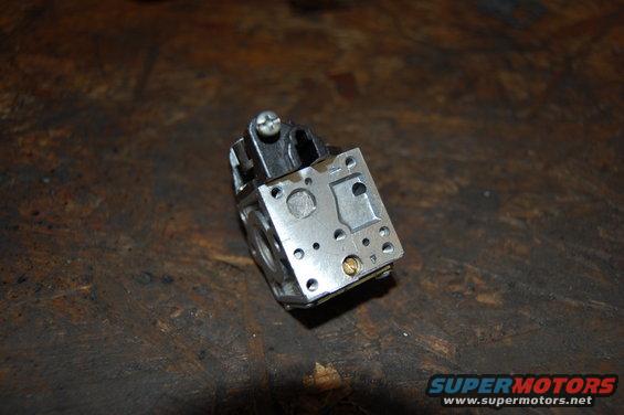 Carburetor part on wooden surface