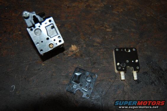 Carburetor components on a dark surface