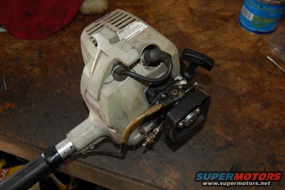String trimmer engine with carburetor visible