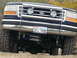 1995 Ford Bronco - This lifted Ford truck features a prominent brush guard and auxiliary lighting, with a Texas license plate.