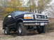 1995 Ford Bronco - This lifted Ford Bronco is equipped with large off-road tires and auxiliary lights on the grille.
