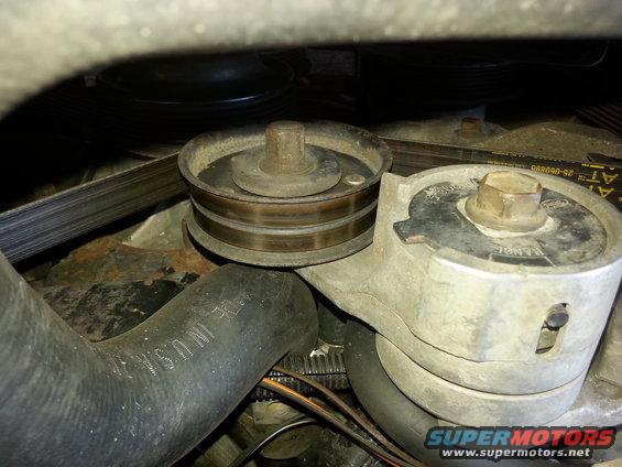 Belt tensioner assembly with pulleys and belt