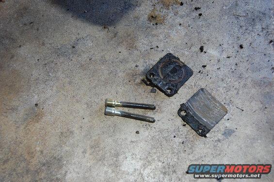 Brake caliper parts and pins on concrete floor