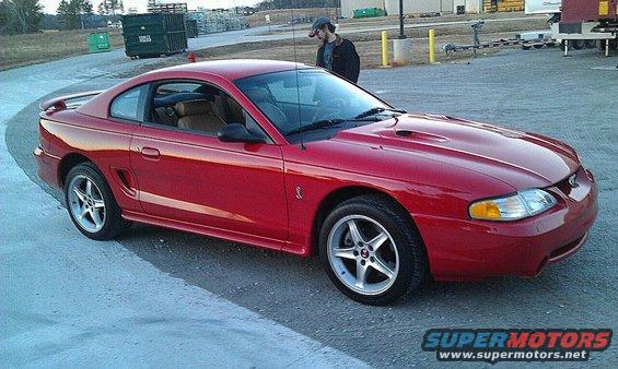 Red 1997 Ford Mustang Cobra coupe parked on pavement