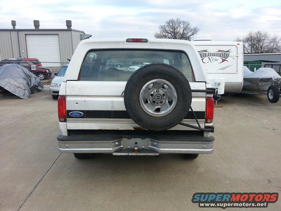 Rear view of a white 1996 Ford Bronco with a spare tire on the back door