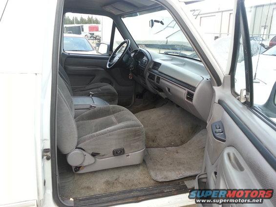 Interior view of a 1996 Ford Bronco showing front seats, dashboard, and door panel