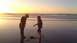 1996 Ford Bronco - A sunset scene unfolds on the beach with two individuals silhouetted against the golden sky.