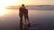 1996 Ford Bronco - Sunset over the ocean with a mother and child standing on the beach.