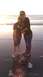 1996 Ford Bronco - A mother and child embrace on the shore as the sun dips below the horizon.
