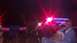 1996 Ford Bronco - A man and his dog are seen at night with a trailer and a dark SUV, illuminated by flashing red lights.