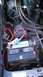1990 Ford Bronco - Close-up view of a vehicle's engine bay, focusing on the battery and associated wiring.
